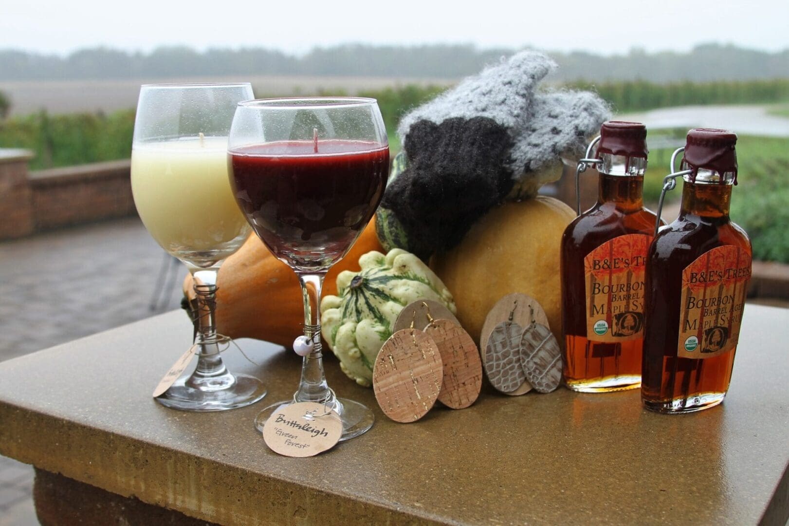 A table with a glass of wine and a pumpkin.