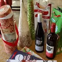 A table full of wine bottles and christmas decorations.