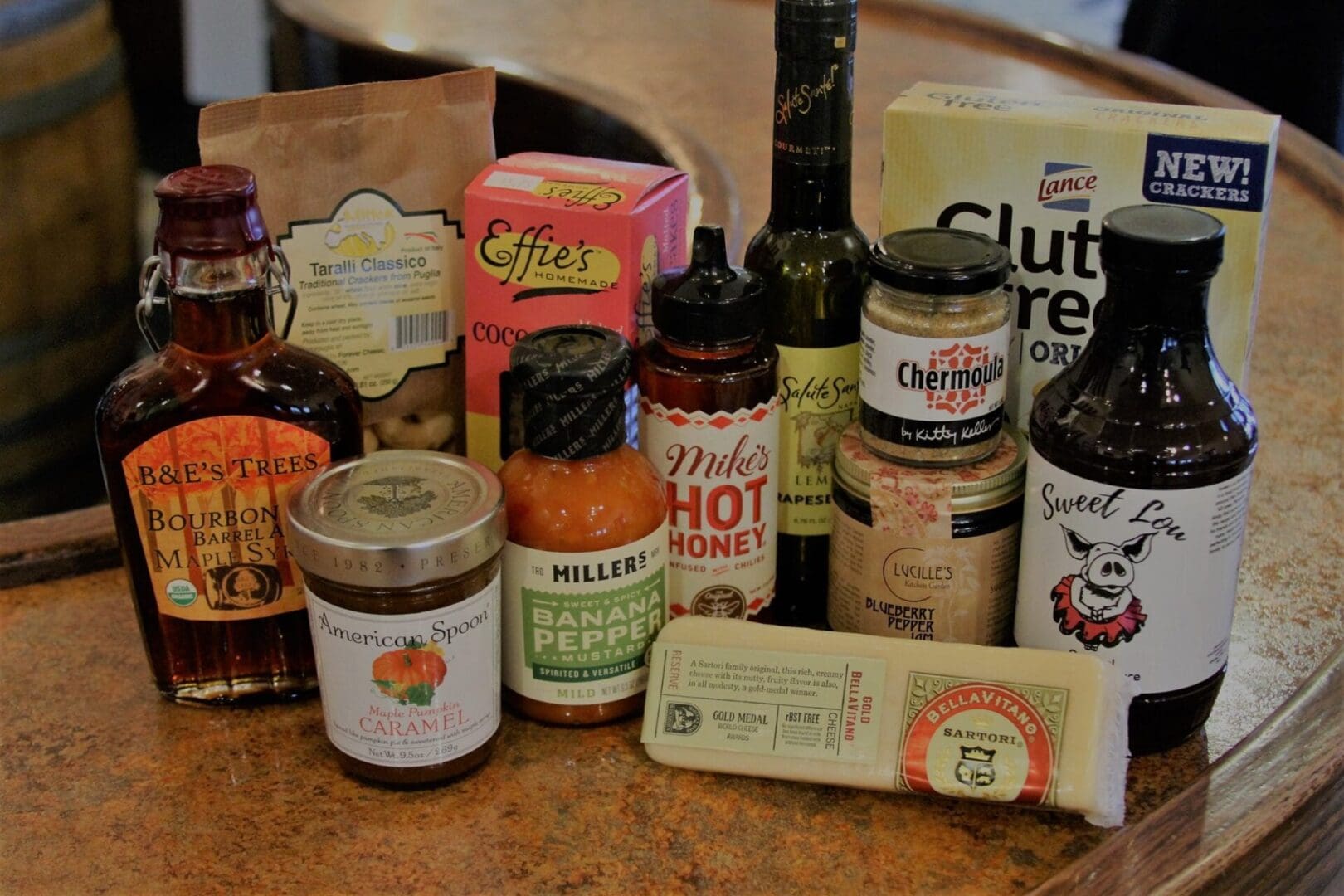 A variety of sauces and condiments are sitting on a counter.