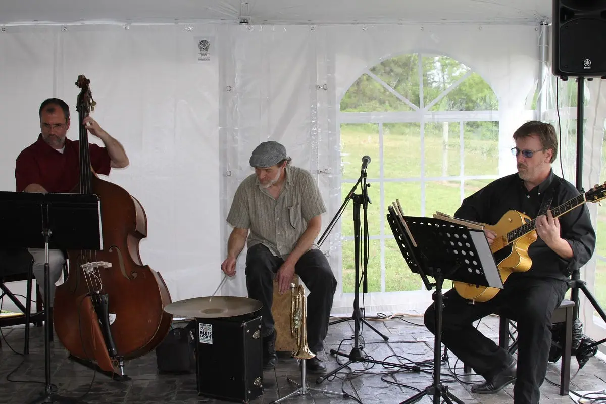 A group of musicians playing music in a tent.