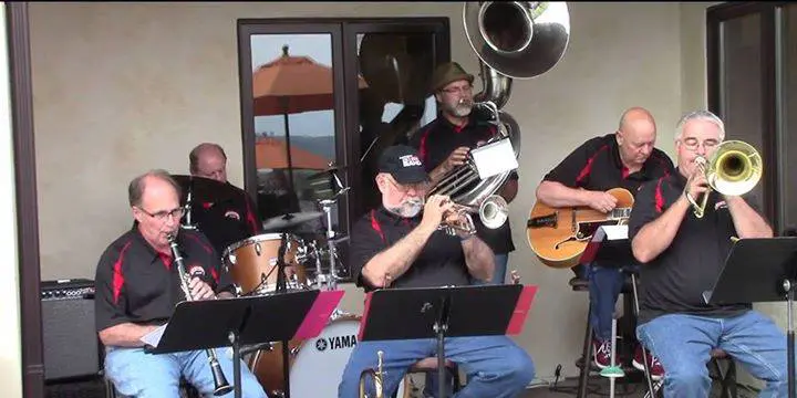 A group of men playing music on a patio.