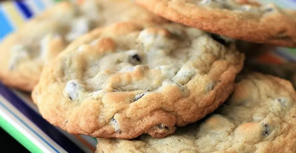 A stack of chocolate chip cookies on a plate.