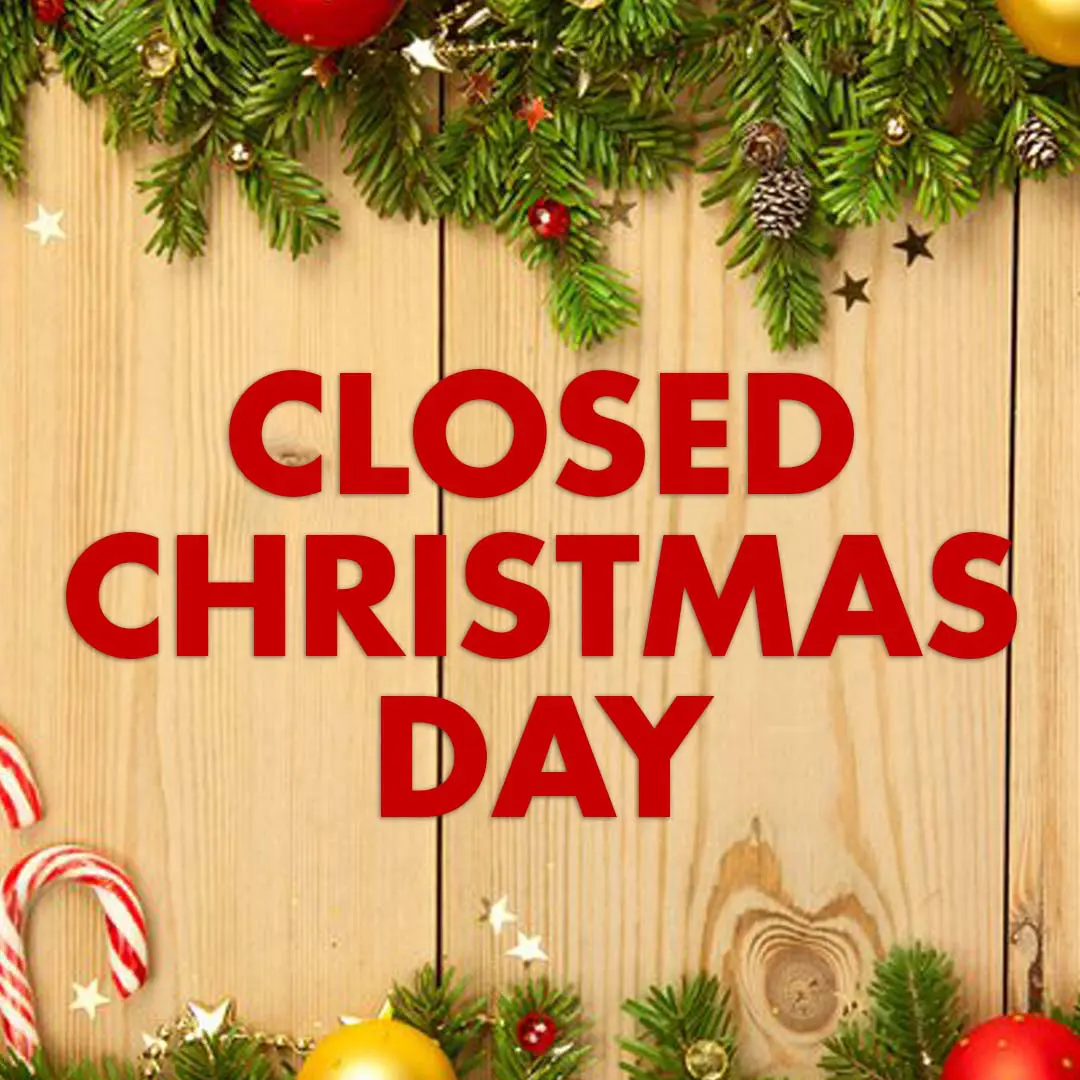 A sign that says closed christmas day on a wooden background.