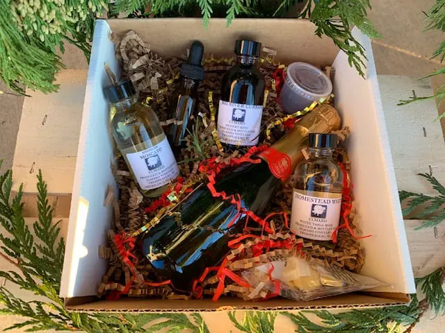A box with a bottle of champagne and other items.