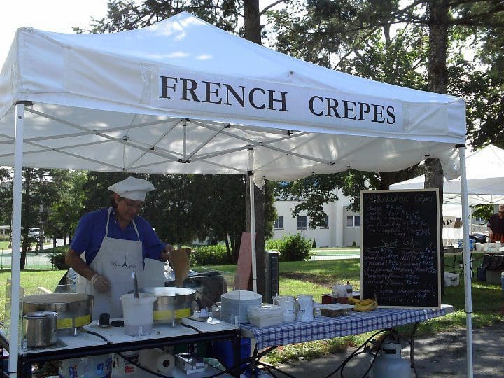 A french crepes stand at an outdoor market.