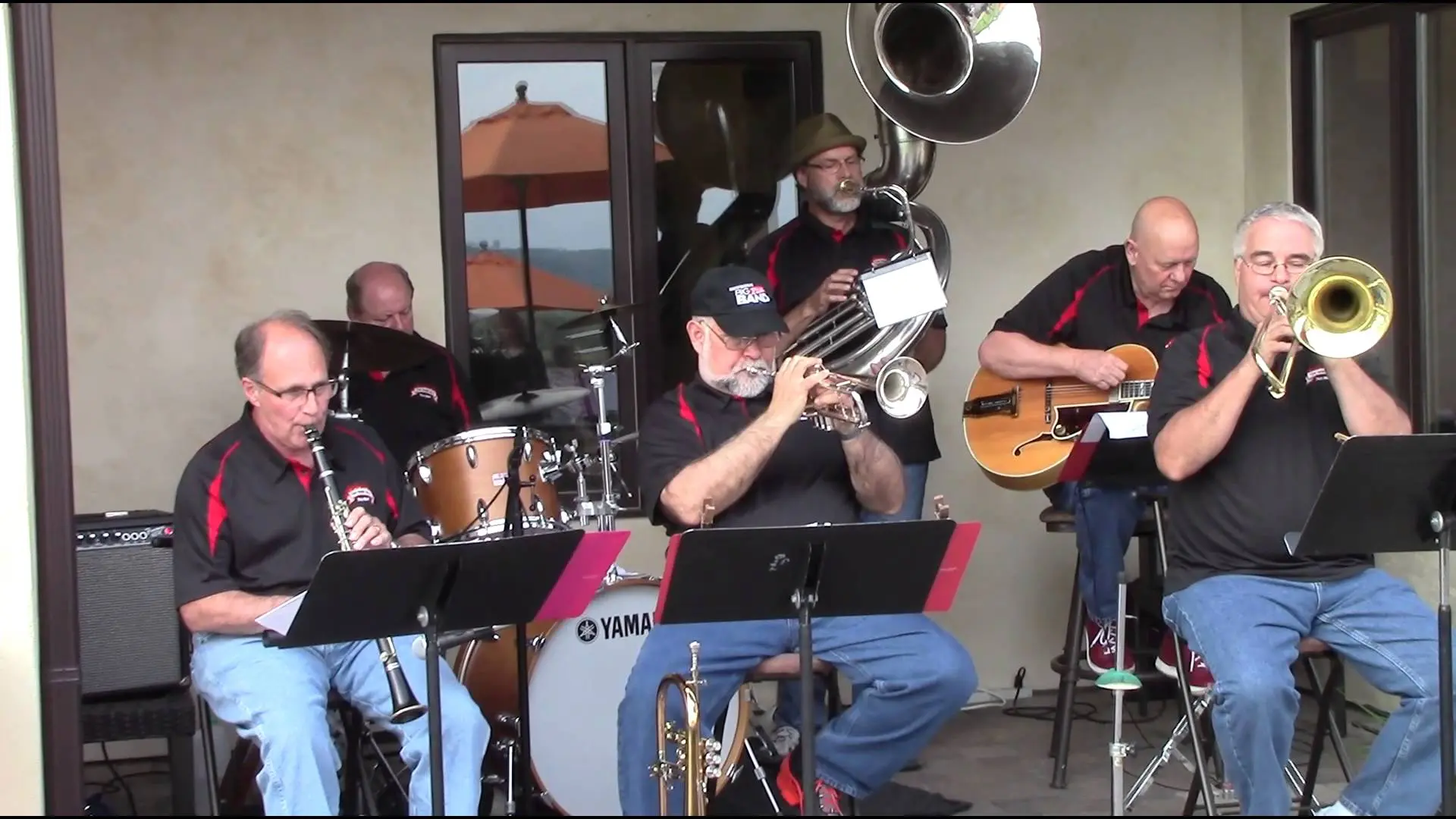 A group of men playing music on a patio.