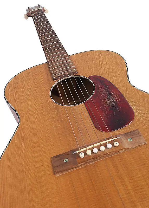 A brown color guitar with a white background