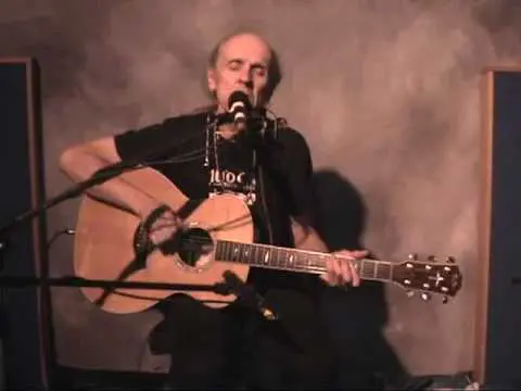 James Grant singing with a guitar in his hand