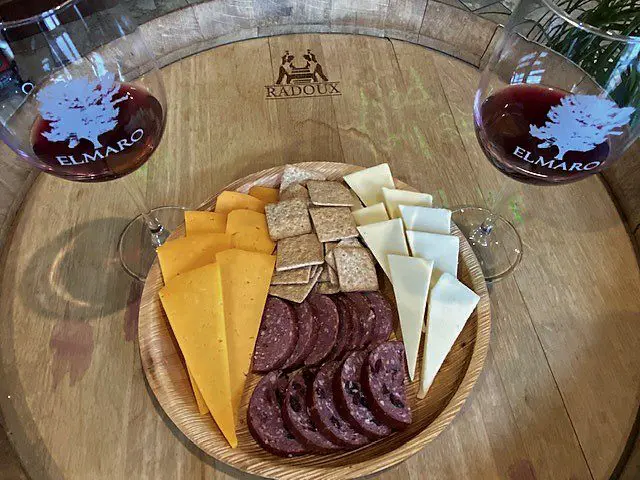 A cheese and crackers meal with wine