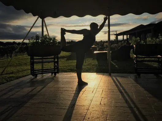 A silhouette of a person doing yoga