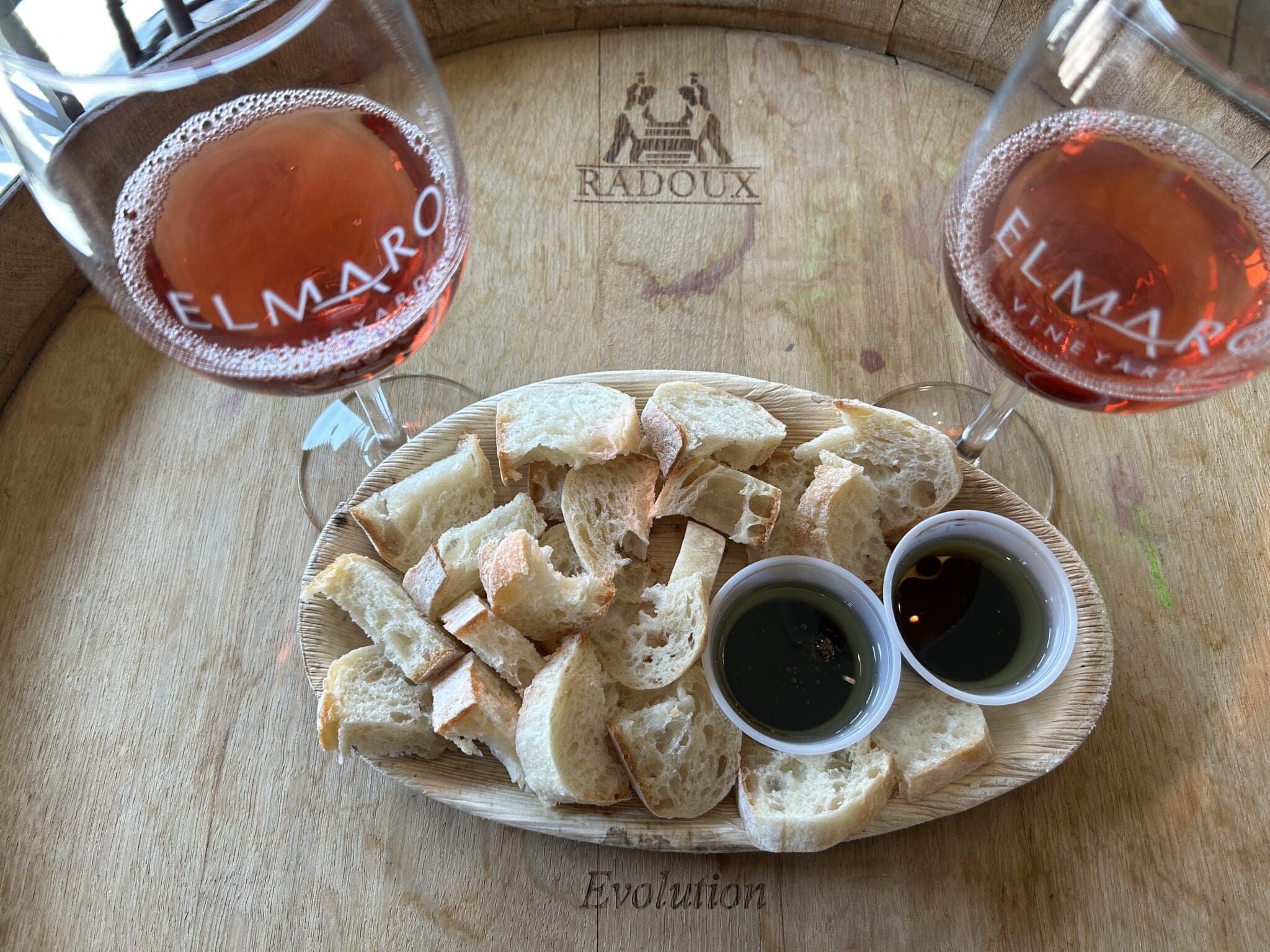 Two glasses of wine and bread with dips.