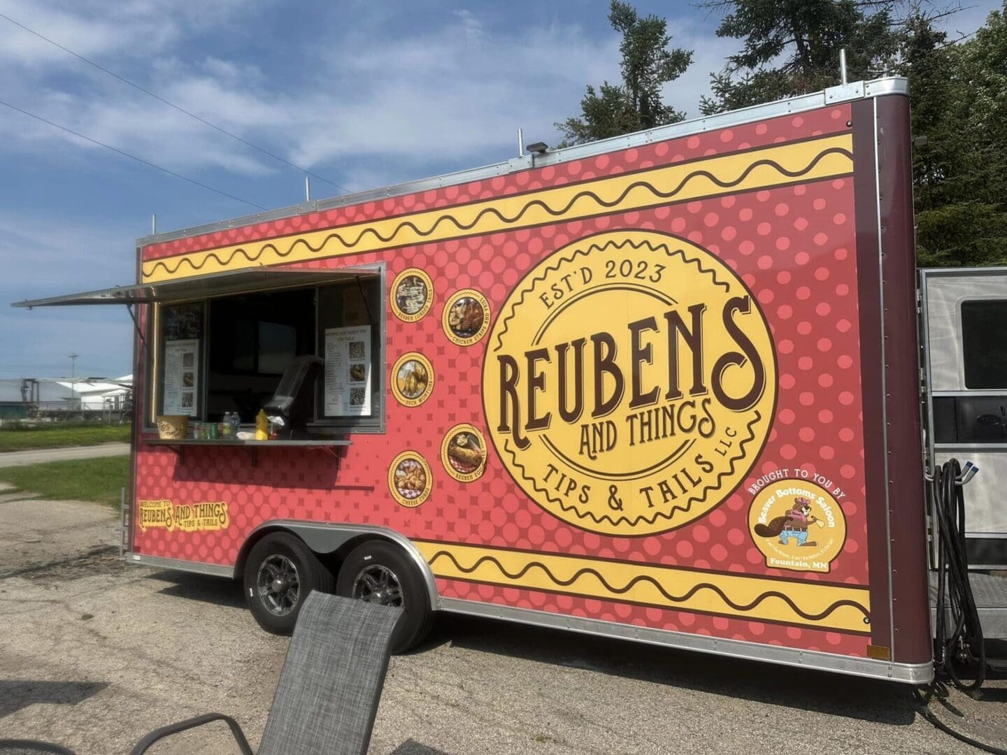 A colorful food truck named Reubens and Things with its service window open.